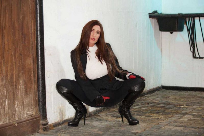 Miss Hybrid leather gloves and boots leg raised and easy access jodhpurs in the stables.