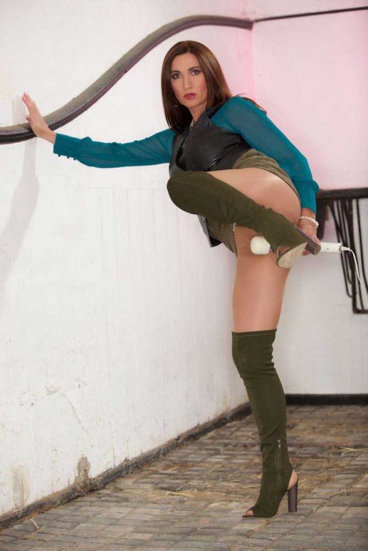 Miss Hybrid leather vest sexy nylons and boots in the stables playing with her Magic Wand.